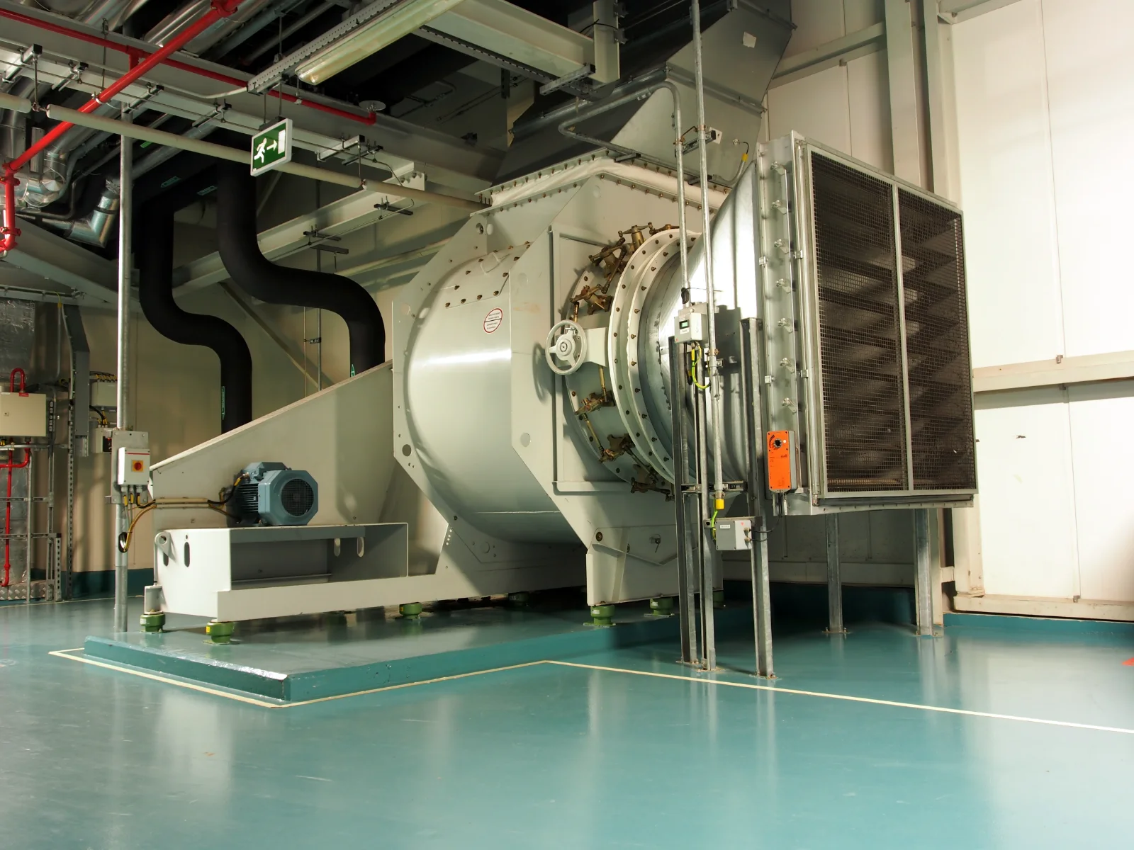 Large centrifugal ventilation fan with motor, inlet grille and connected ductwork