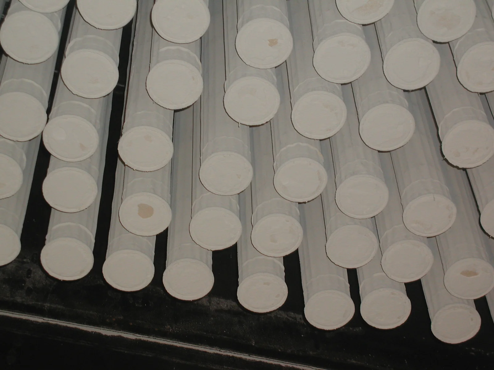 Rows of fabric filter bags inside an industrial baghouse dust collector